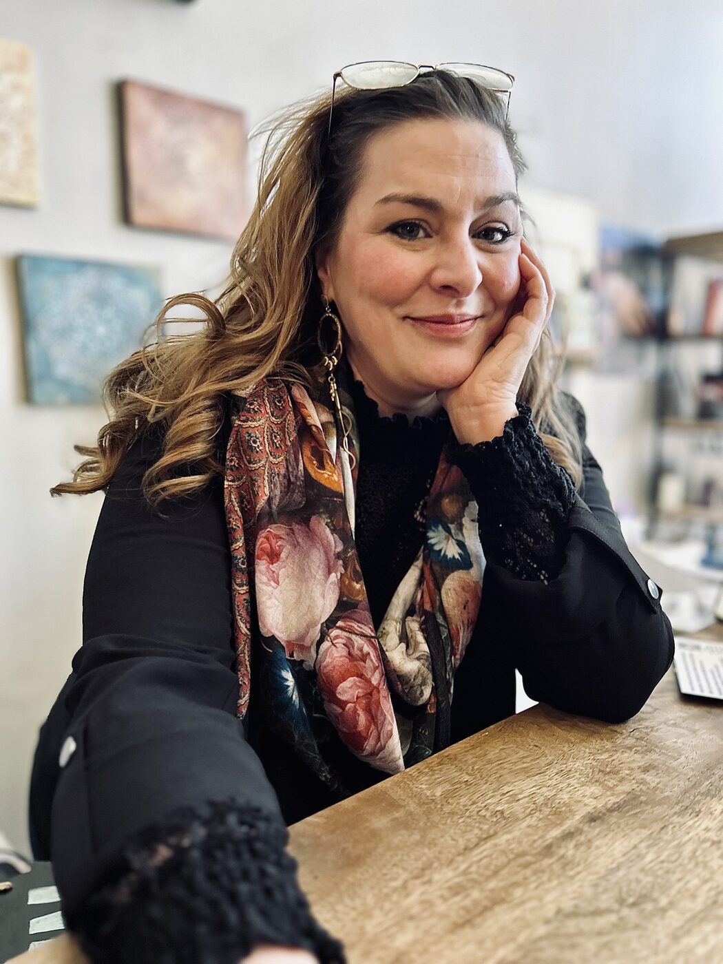 Marisa McFadden resting her chin on her hand at the shop counter